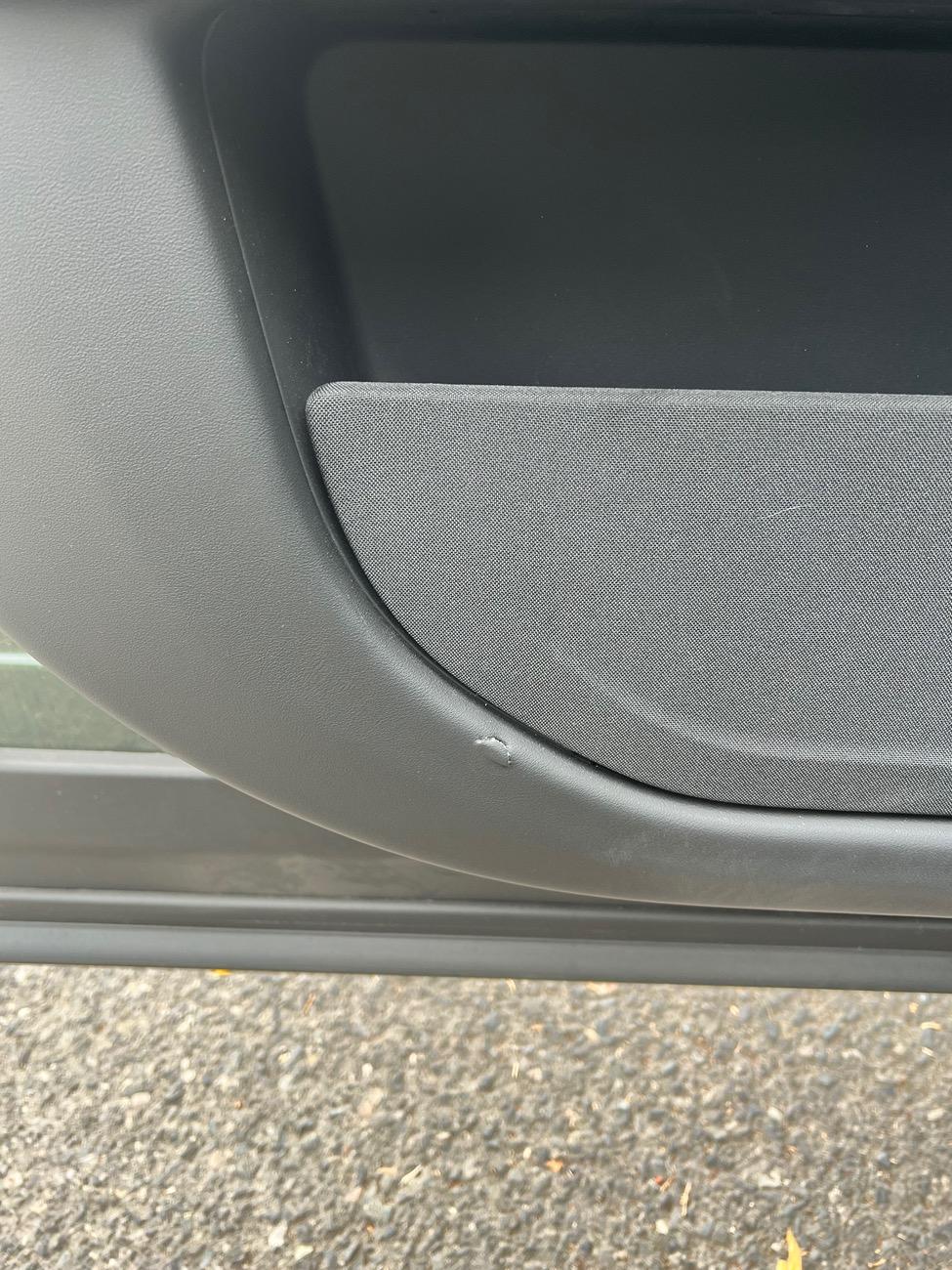 Rivian R1T R1S Little rip in door leather IMG_2584
