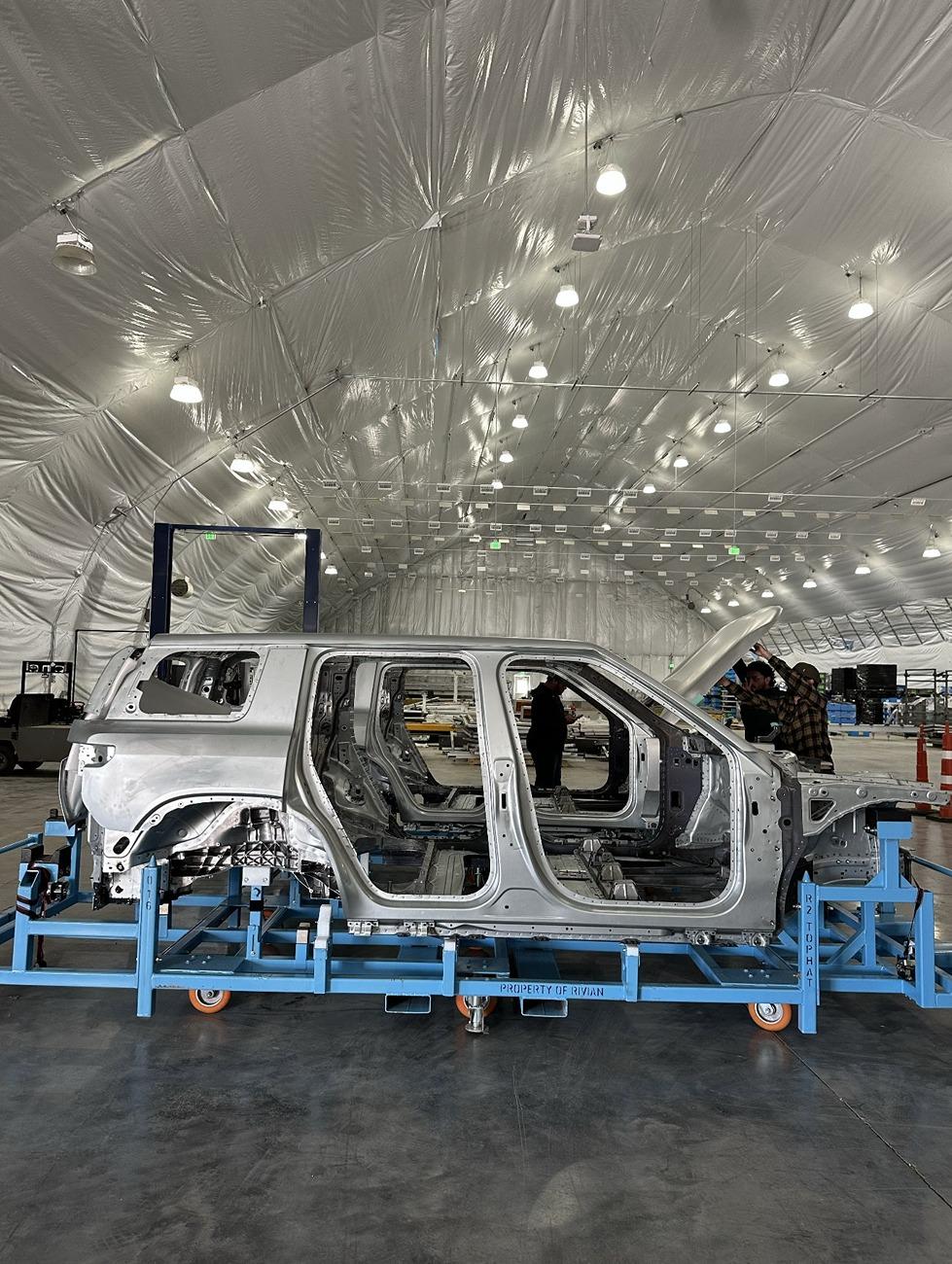 Rivian R1T R1S Photo: R2 body built w/ production dies! NACS charge port location = driver's side ? r2 body production