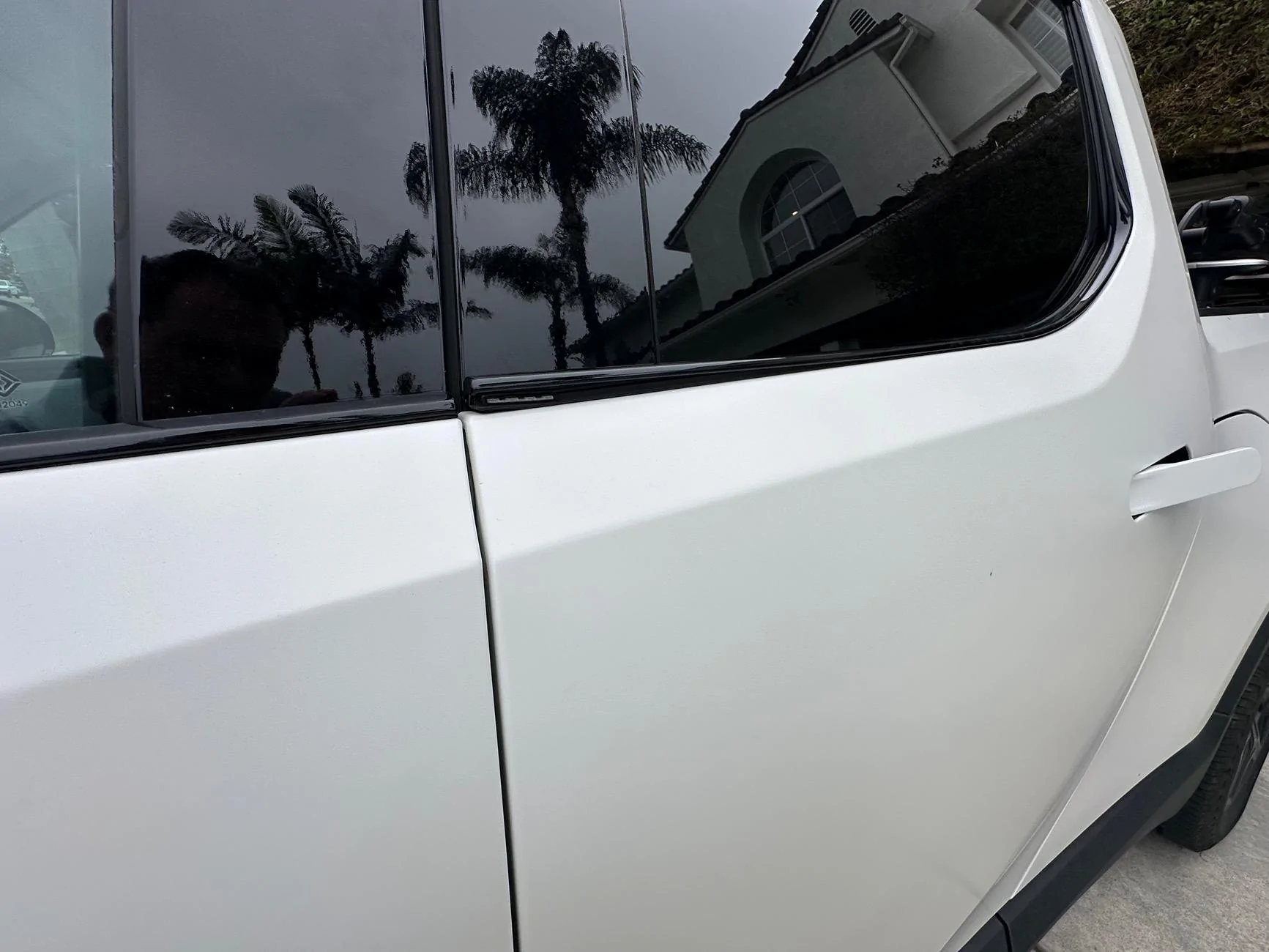 Rivian R1T R1S Rear door window lower trim bending up again IMG_2073
