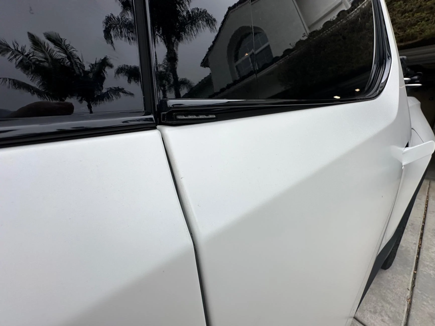 Rivian R1T R1S Rear door window lower trim bending up again IMG_2074