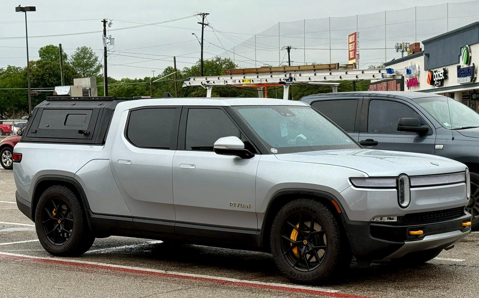 Rivian R1T R1S Front appearance improvement with vinyl on front light bar + side stripes! IMG_4479