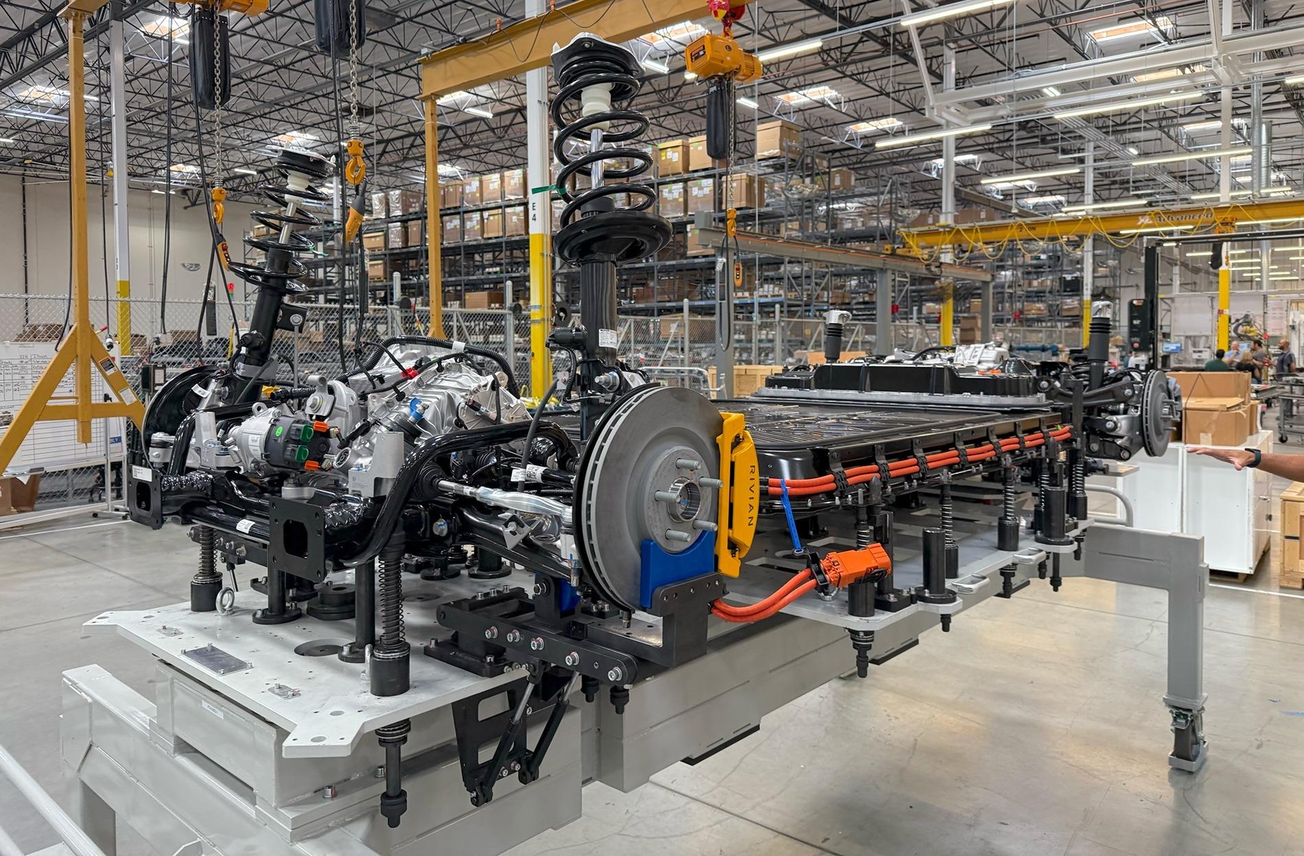 Rivian R1T R1S R2 photo from RJ: "R2 battery, propulsion and chassis in marriage fixture before assembly to the body in our CA pilot line." Gwjx5V3bkAAdOym