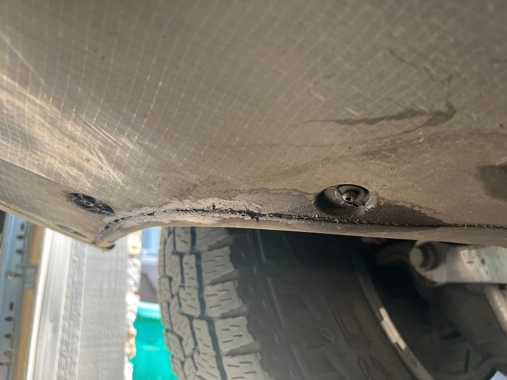 Rivian R1T R1S Fluid leak at rear drivers side - oily substance IMG_3944