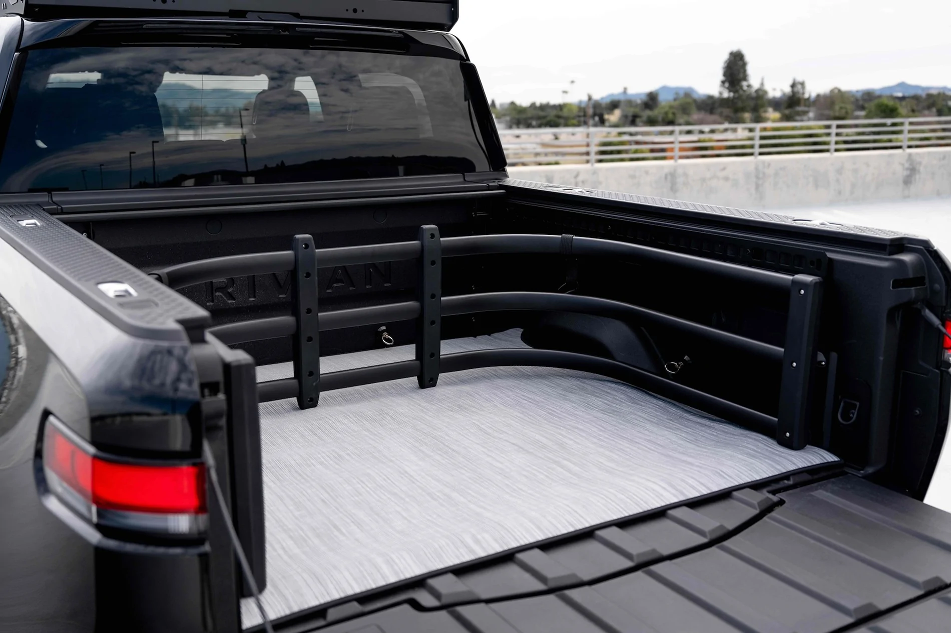 Rivian R1T R1S Rivian Partners with EV Sportline to Offer R1T Bed Extender Through Official Gear Shop midnight-rivian-r1t-bed-extender-mat-3s