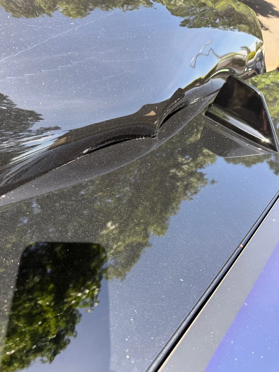 Rivian R1T R1S R1S lift gate hit the roof damaging the lift gate and the roof IMG_1961