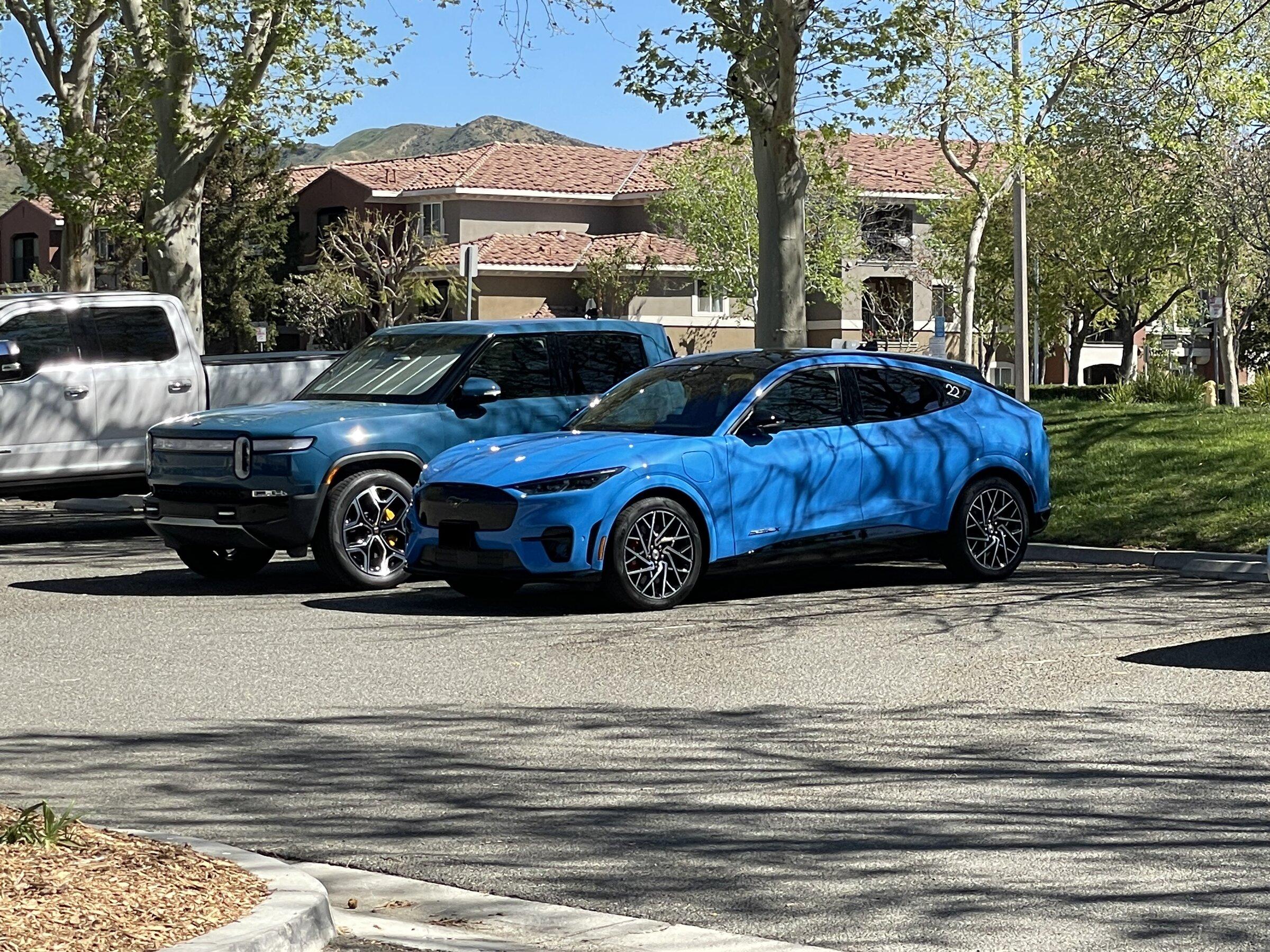 Rivian R1T R1S Rivian Blue R1T vs Grabber Blue Mach-E GT a side by side comparison look image_17215233-