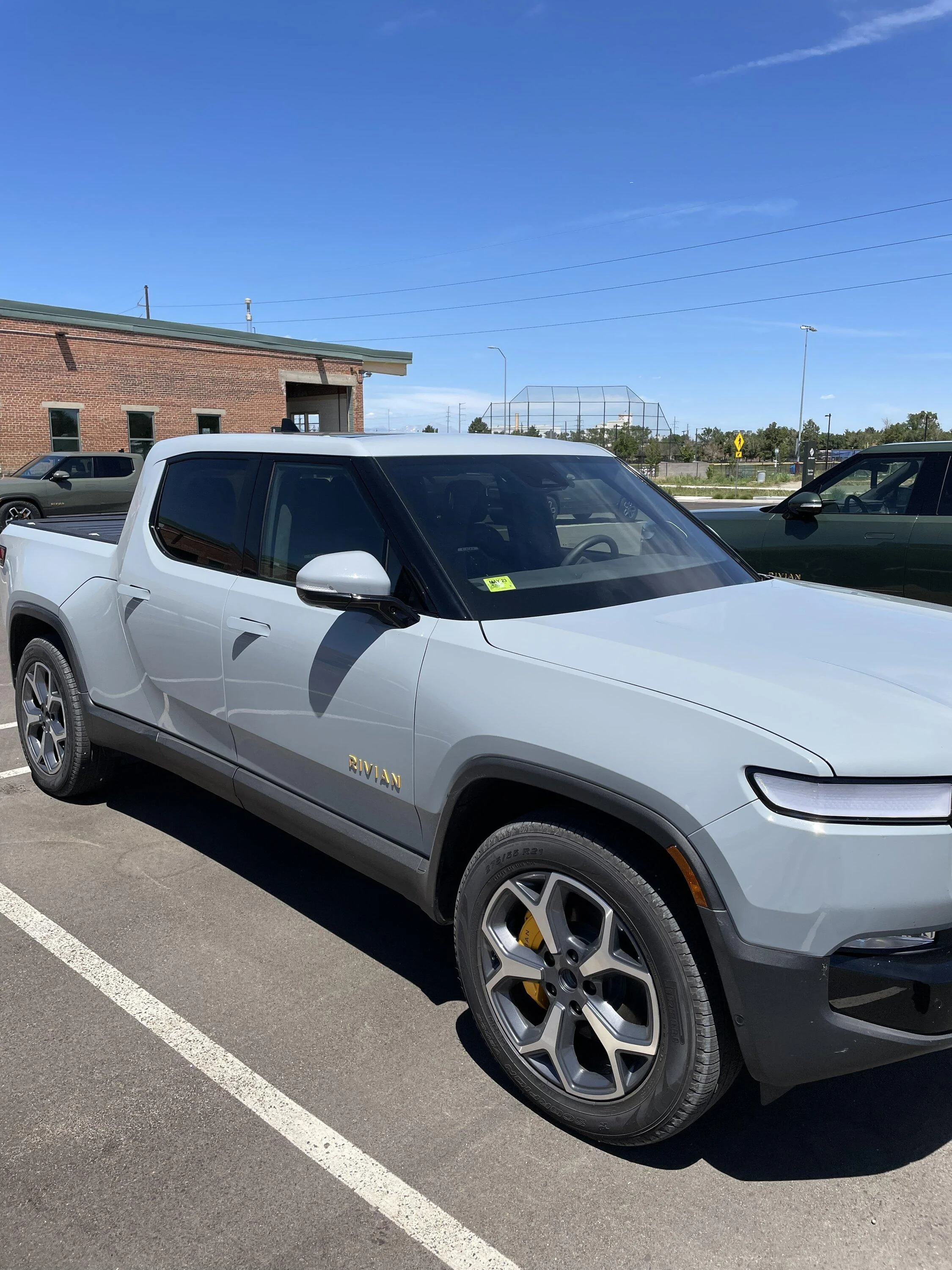 Rivian R1T R1S Limestone next to Subaru's light blue 15C84B86-B7B4-4464-B48C-B2340DD2DA97