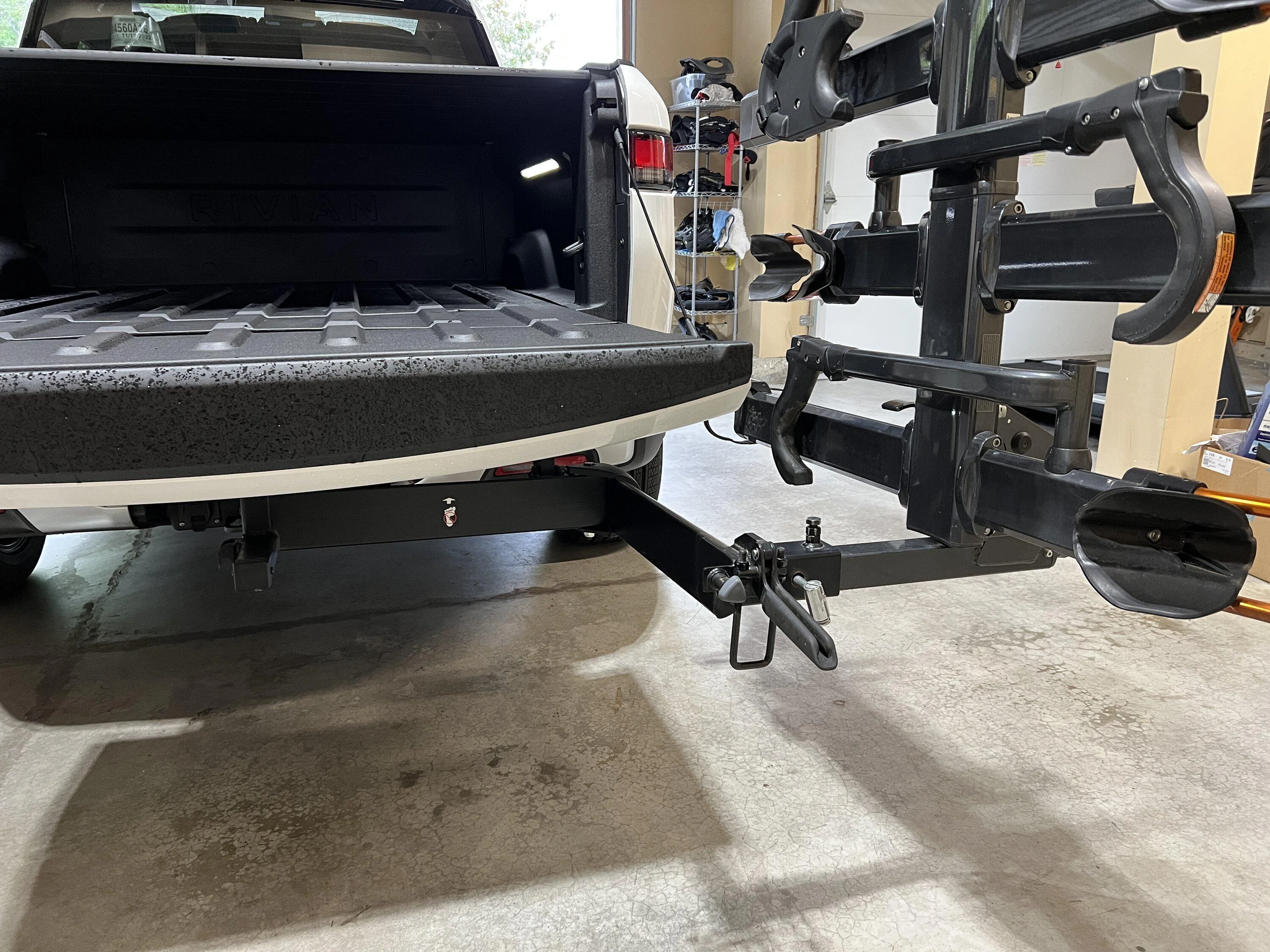 Rivian R1T R1S Installed Kuat NV 2.0 bike rack with Yakima BackSwing A4A8CEF6-8F70-4905-A58C-569E4A4A430B