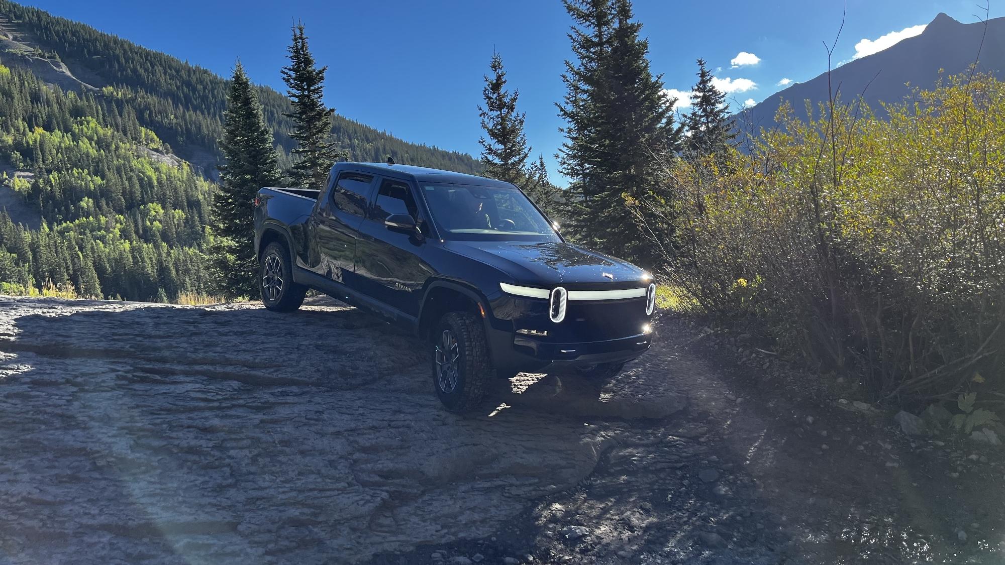 Rivian R1T R1S R1T Over Imogene Pass, CO crawling down a rock