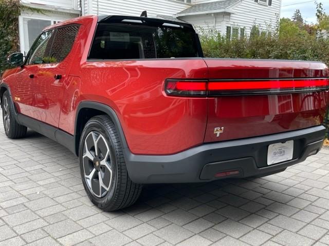 Rivian R1T R1S Red Canyon / Ocean Coast R1T with XPEL OEM PPF, tailgate partial de-badge, and bumper vinyl wrap R1T tailgate de-badge