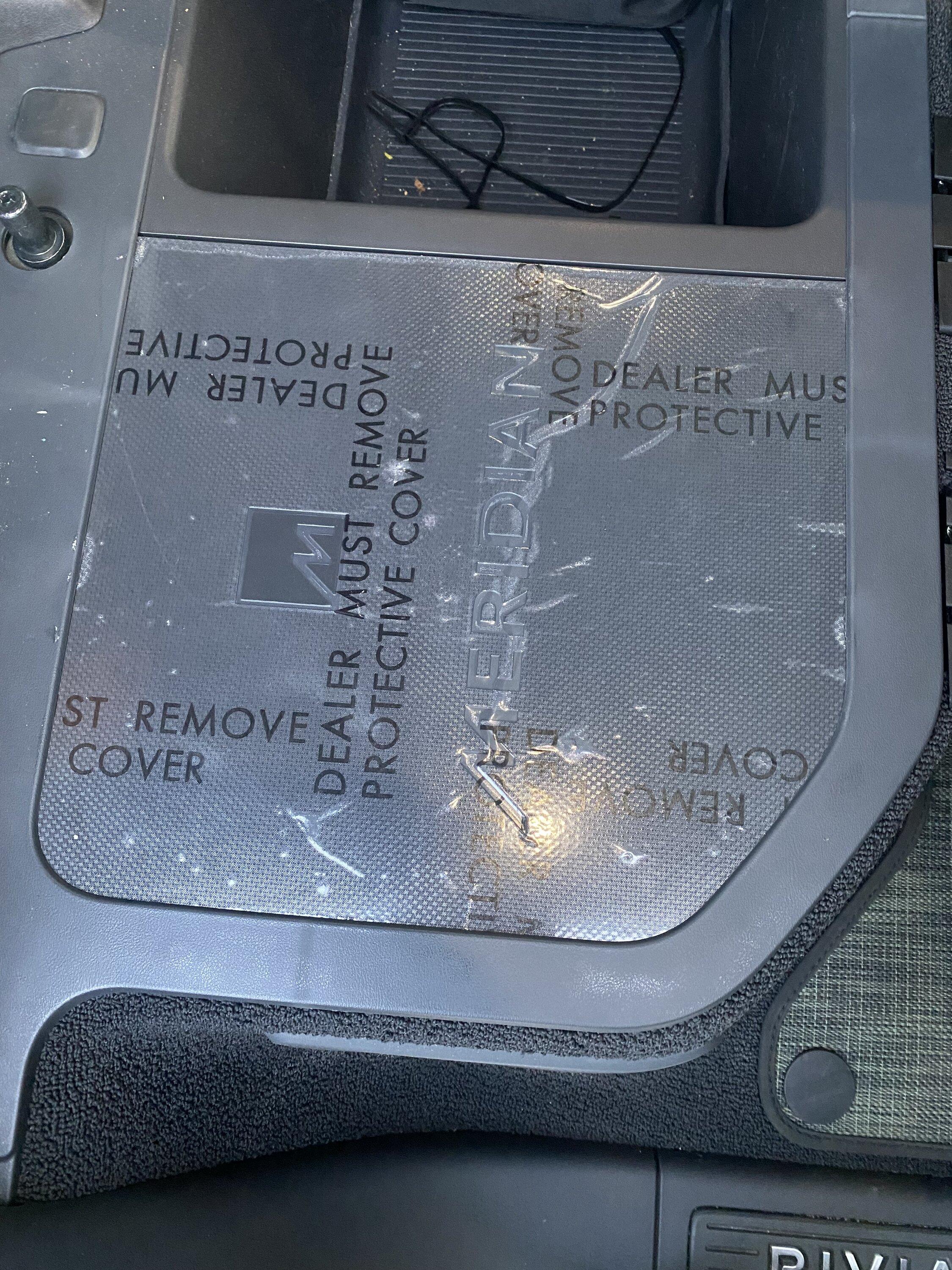 Rivian R1T R1S Factory plastic cover on Meridian audio system IMG_6043