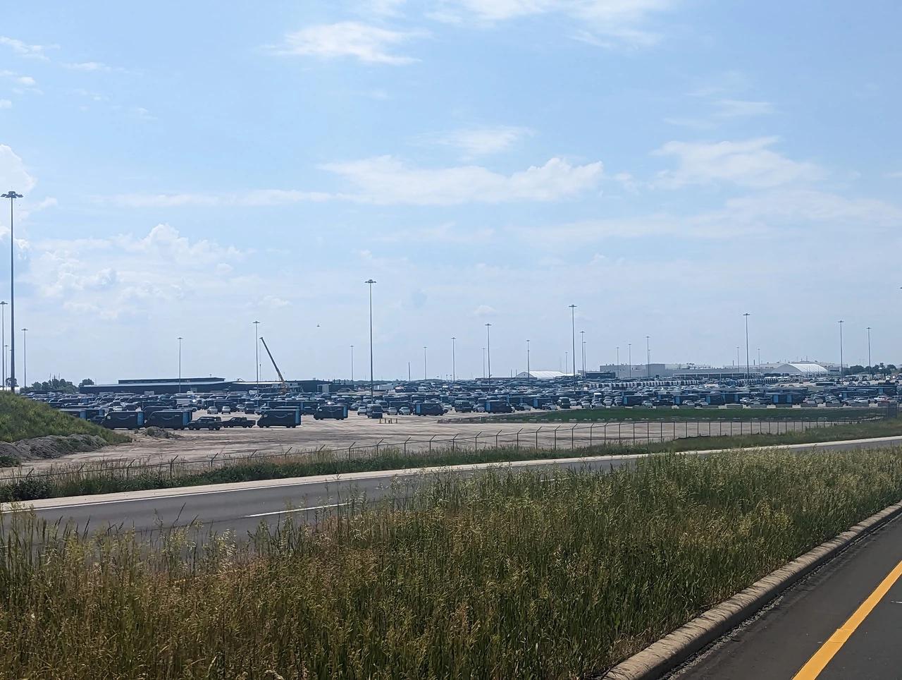 Rivian R1T R1S Thousands of Rivian R1 and EDV waiting to be delivered from Normal Plant (6/1/23 photo) rivian parking lot normal plant