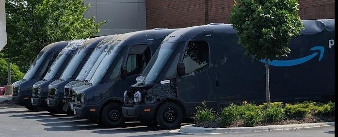Rivian R1T R1S Amazon vans at collision repair SsMjNCv