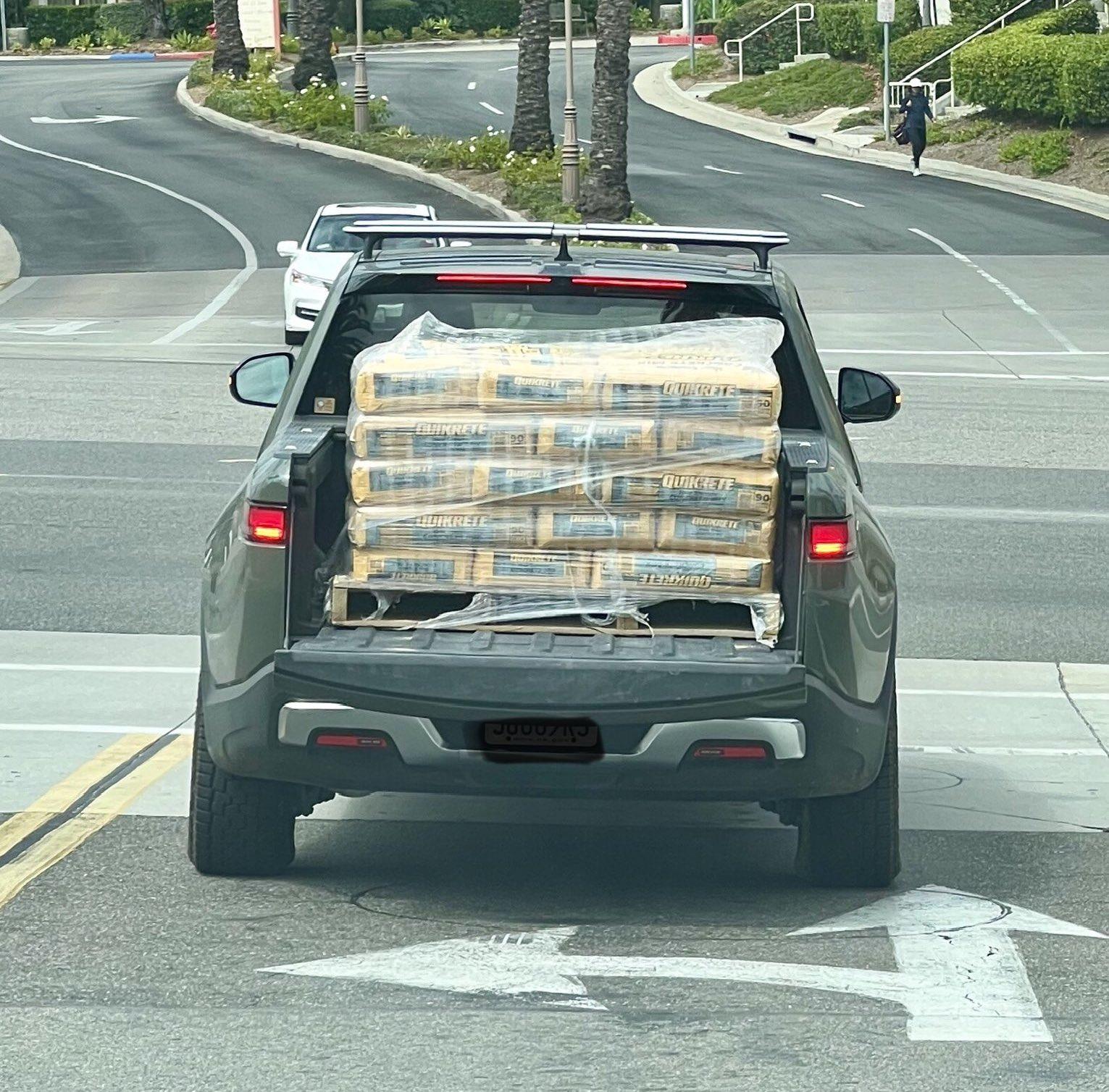 Rivian R1T R1S What Are You Hauling (or Hauled) in your Rivian? 🦾 rivian-r1t-gets-the-toughest-of-jobs-squats-while-hauling-a-pallet-of-concrete-mix_2