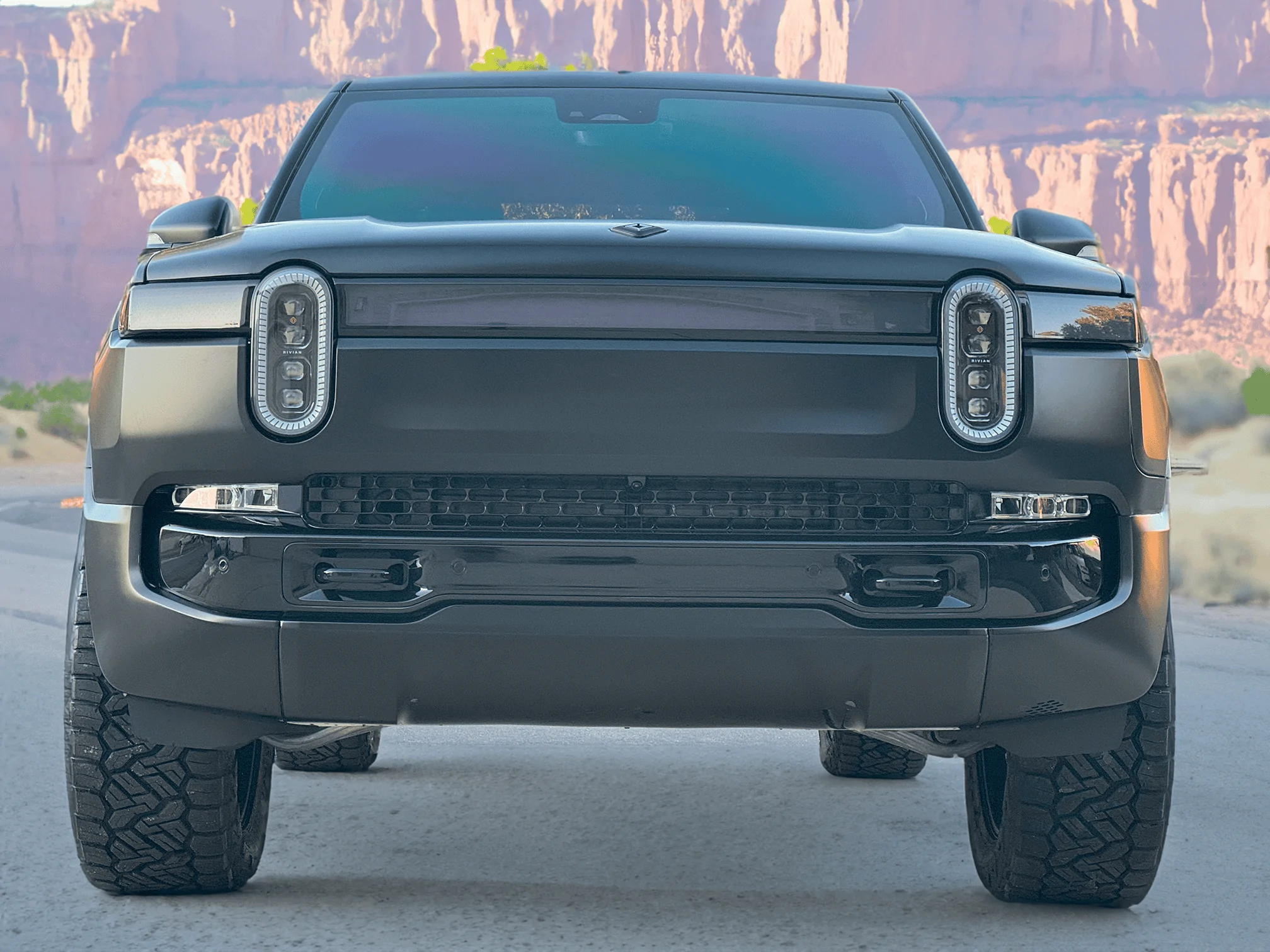 Rivian R1T R1S Project Midnight R1T Front lights off moab cliffs in background small
