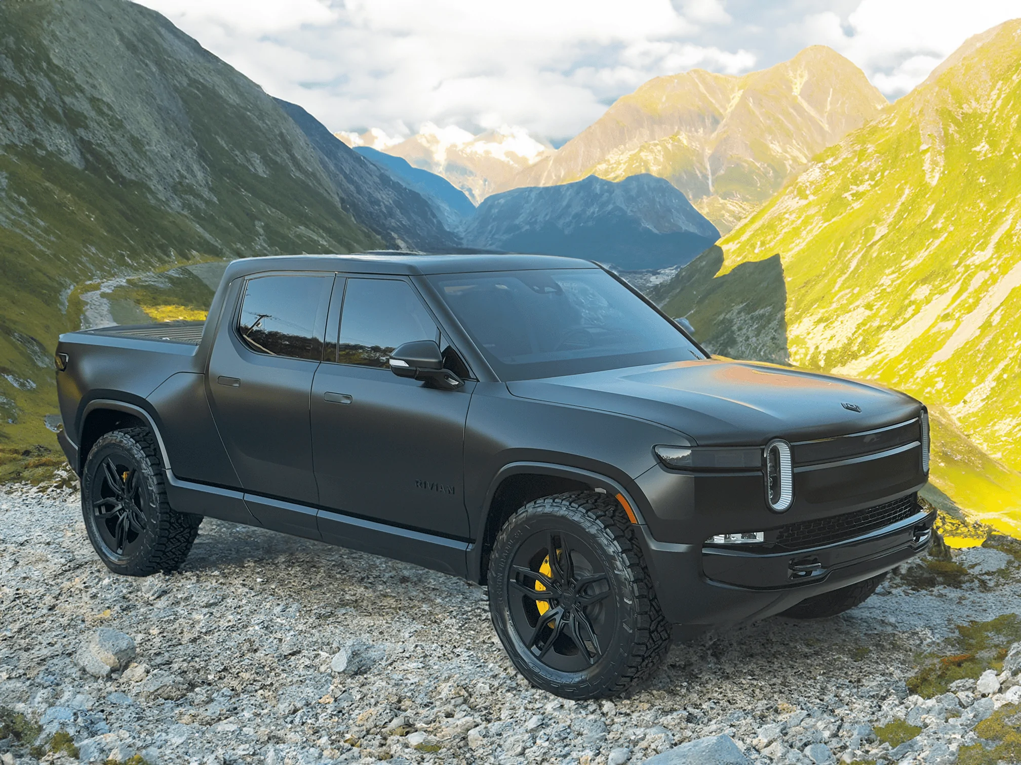Rivian R1T R1S Project Midnight R1T ad-with-tall-mountains-in-teh-background-small-png