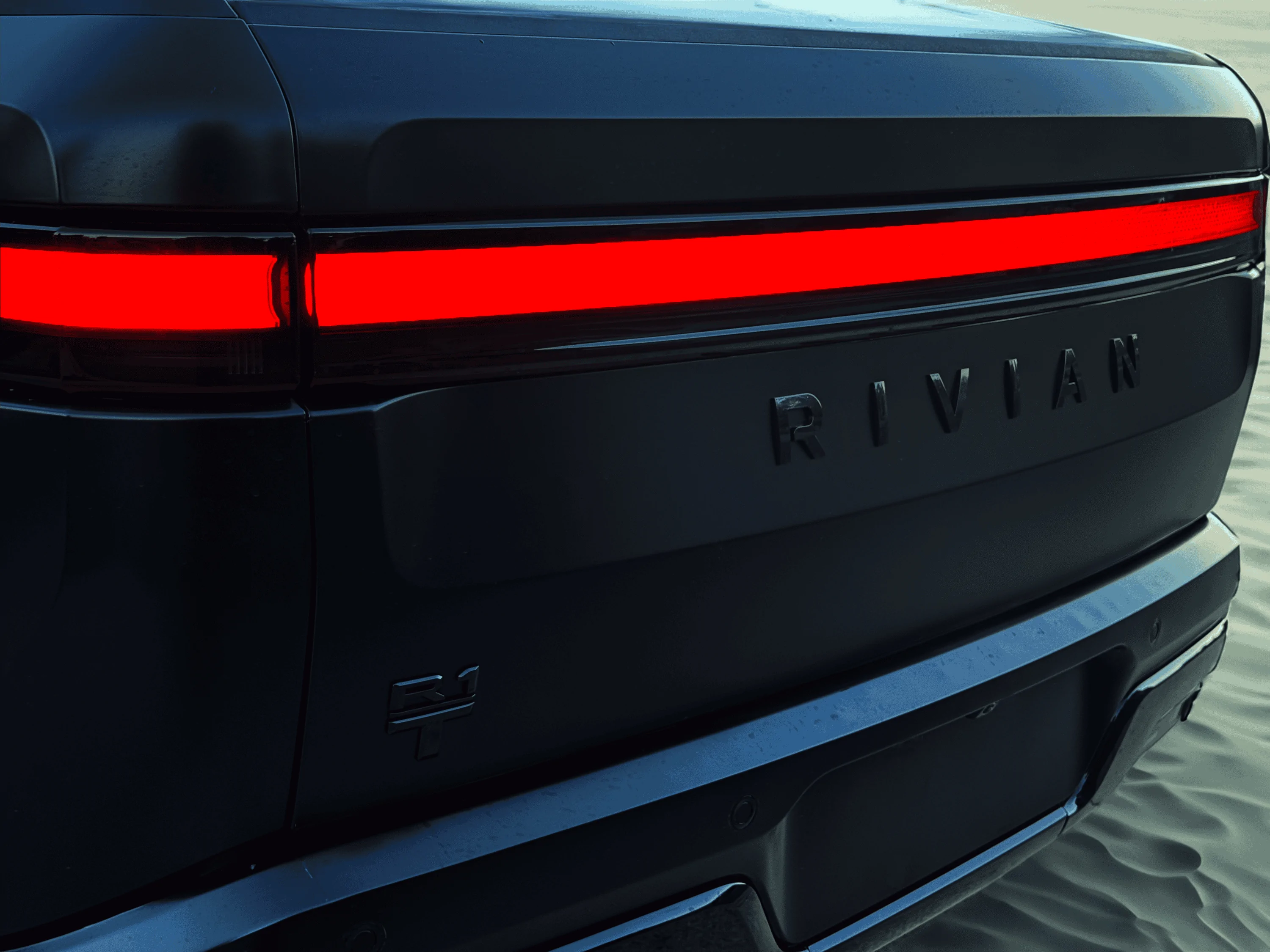 Rivian R1T R1S Project Midnight R1T Rear Sahara at night