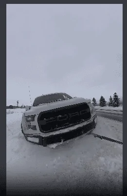 Rivian R1T R1S Rivian R1T pulls a stuck F-150 Raptor out of the snow [video] 1705621396323