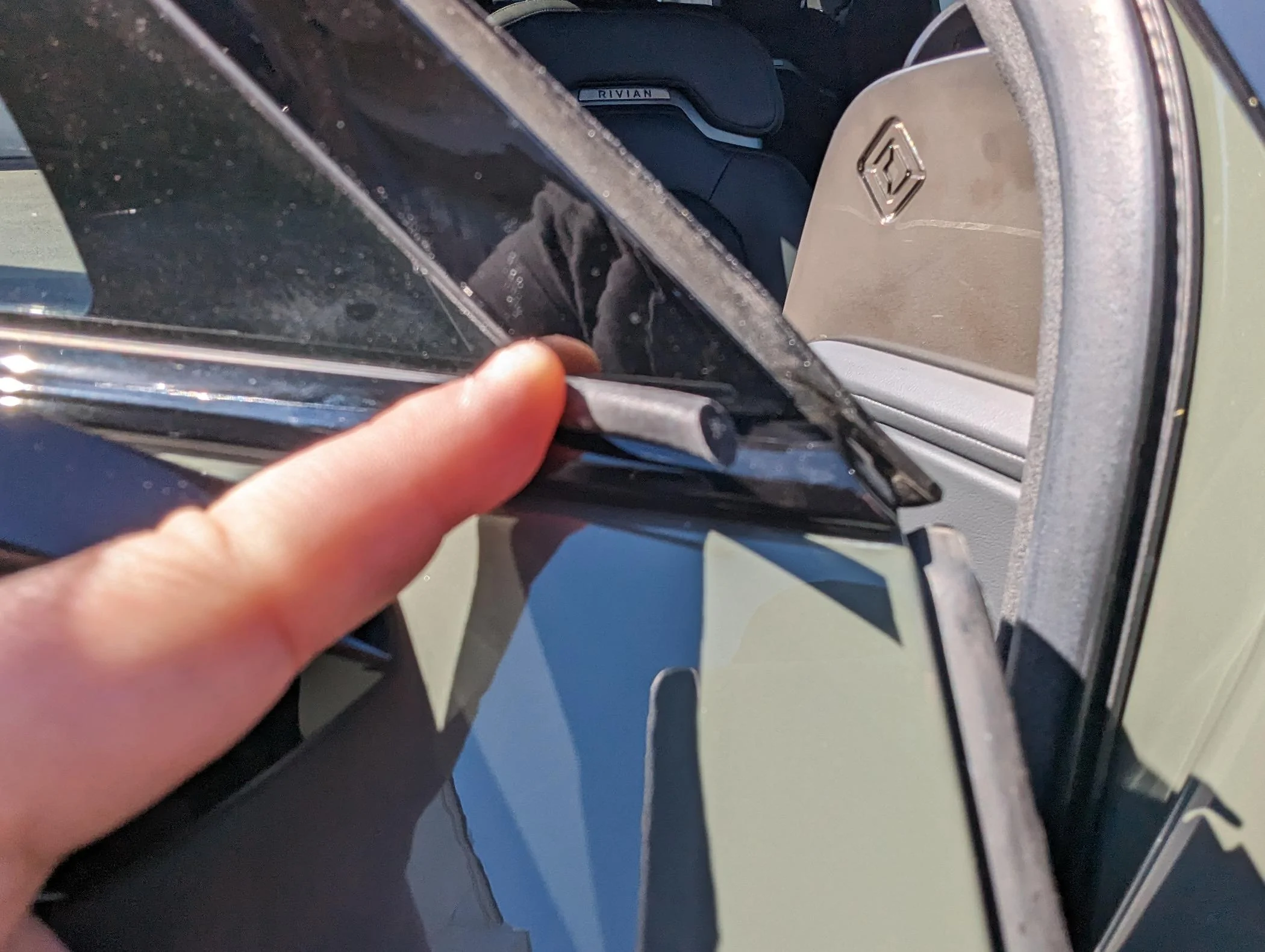 Rivian R1T R1S Resolved (my) excessive wind noise 2023 R1T (cause: corner window plastic trim) PXL_20240324_185249551