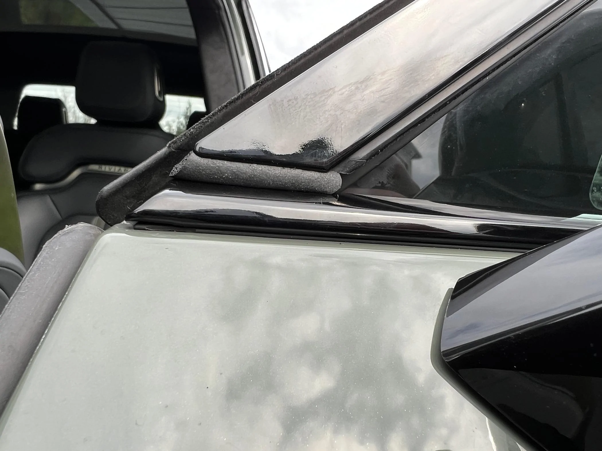 Rivian R1T R1S Resolved (my) excessive wind noise 2023 R1T (cause: corner window plastic trim) IMG_2131