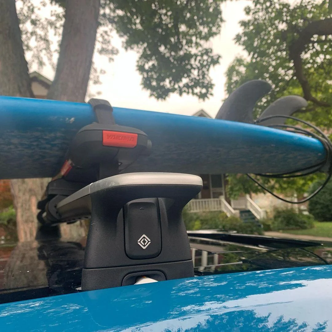Rivian R1T R1S Yakima SUPDawg SUP Rack on Rivian R1T roof rack bars - carrying surfboard Rivian R1T Yakima SUPDawg on Rivian roof rack bars - holding surfboard 4