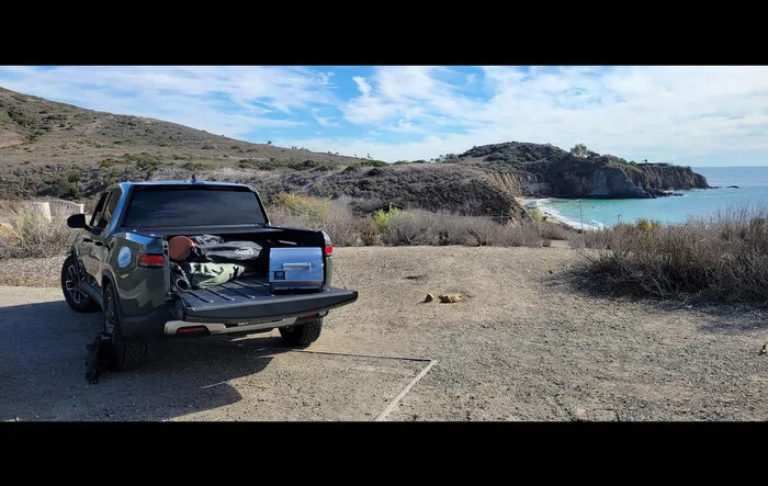 Camping with R1T and Electric Grill at beach cliff edge
