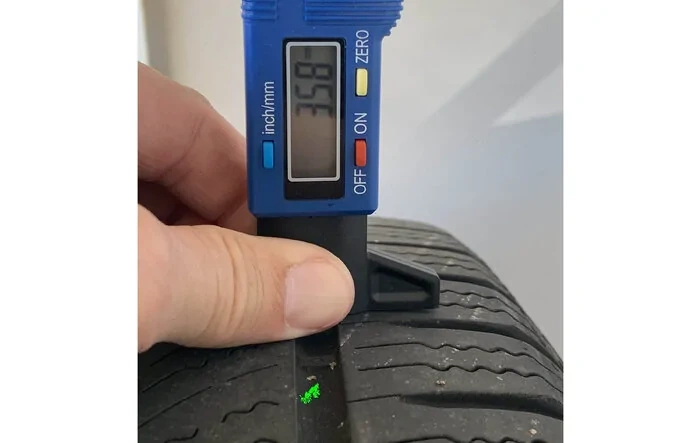 OEM tires (22" Sport Tires) after 22K+ miles—tire tread depth remaining measurements