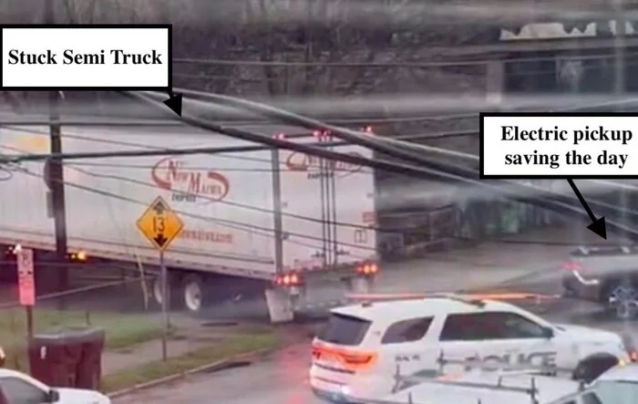 Rivian R1T saves a stuck semi by pulling it out of mud in Covington, KY
