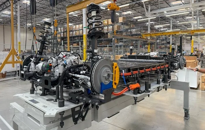 R2 photo from RJ: "R2 battery, propulsion and chassis in marriage fixture before assembly to the body in our CA pilot line."