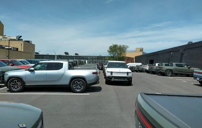 Current look at Brooklyn Rivian Service Center's parking lot full of R1T